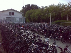 delft_bicycles_1024 The most relevant image I could find: The overfull bicycle parking behind Delft station on Thursday just after noon, right before leaving for the NFBI meeting in Leiden. Turns out that in the Netherlands, there's on average slightly more than one bicycle for each and every inhabitant.